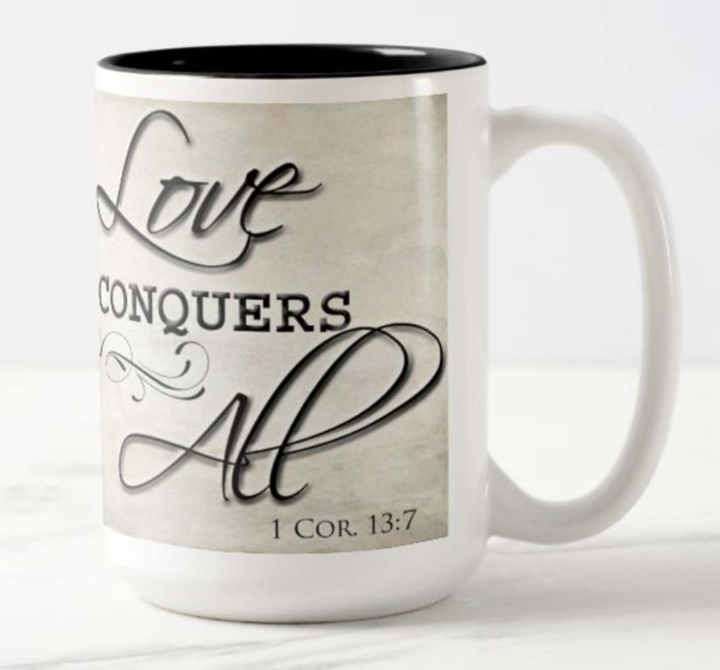 Lovely 15 oz. mug with the inspirational bible scripture "Love Conquers All' and flower photo.